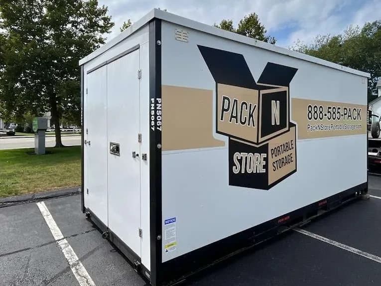 A container in a marked parking bay, plank visible under the corner.